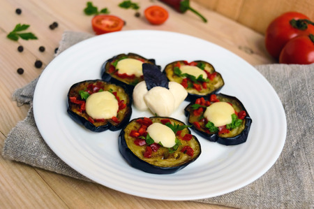 Spicy fried eggplant slices with red pepper, garlic, herbs and mozzarella.の写真素材
