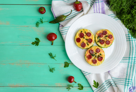 Small zucchini pizza on the circles with pepperoni and mozzarella. The top viewの写真素材
