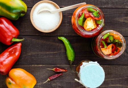 Marinated vegetables in a jar of glass: hot red and green peppers with sugar. The top viewの写真素材