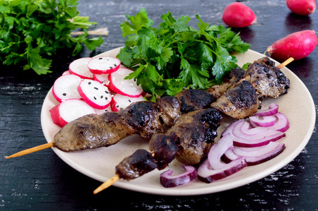 Rabbit liver roasted on skewers  and radish salad. A dietary dish.の写真素材