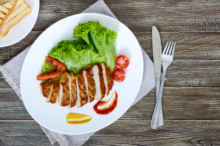 Juicy grilled meat , vegetable, lettuce leaves and sauces. Healthy food.の写真素材