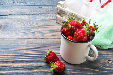 Fresh ripe strawberries in a rustic mug on a wooden table. Freshly harvested crop.の写真素材