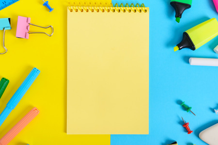 School accessories on a yellow-blue bright background. Back to school concept. Office and student...