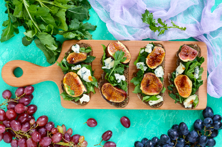 Useful sandwich with figs, blue cheese, arugula, balsamic on whole wheat bread. Healthy eating.の写真素材