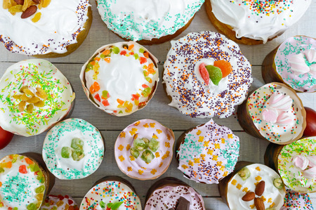 Many different Easter cakes on a white background. Top view. Traditional sweet bread decorated...
