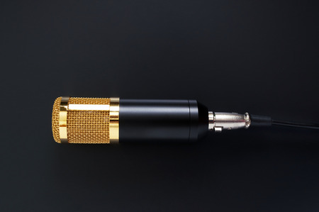 Beautiful golden microphone on a black background. The top view, flat lay.の写真素材