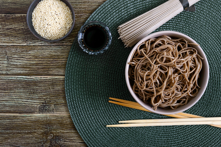 Cold soba (buckwheat noodles) with sauce and sesame. Japanese food. Traditional asian cuisine - noodles from buckwheat flour. Top view, flat lay.の素材 [FY310125107625]