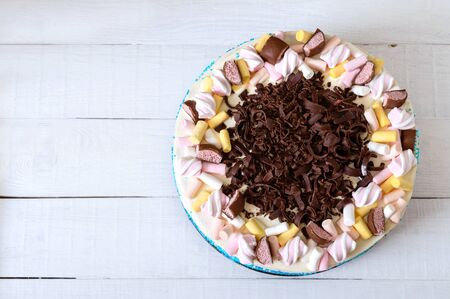Large festive cake decorated with chocolate chips, marshmallows. Copy space for inscriptions. Top...