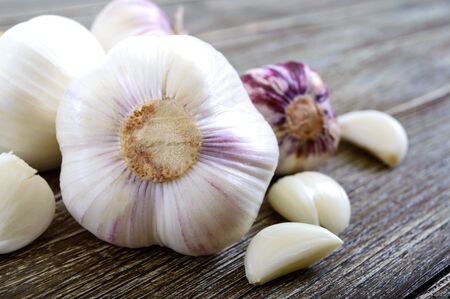 Garlic cloves, garlic bulb on wooden background. Fresh garlic close up. Concept of healthy food.の写真素材