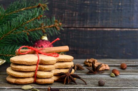 Christmas homemade gingerbread cookies and spices on the wooden background. Christmas mood. Happy...