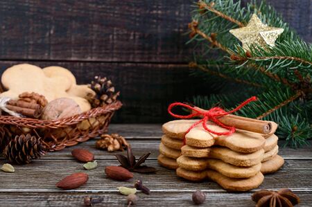 Christmas homemade gingerbread cookies and spices on the wooden background. Christmas mood. Happy New Year and Christmas. Holiday Postcardの写真素材