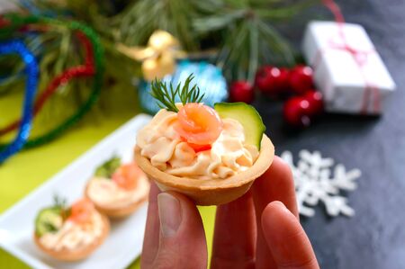 Tartlets with cream cheese and red salted salmon on a white plate for the festive table. Tasty portion light snack for a party. Finger Food.の写真素材