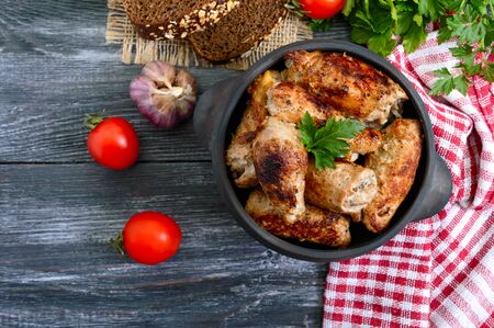 Tasty meat rolls with mushrooms in a ceramic pot on a wooden background. Top view.の写真素材