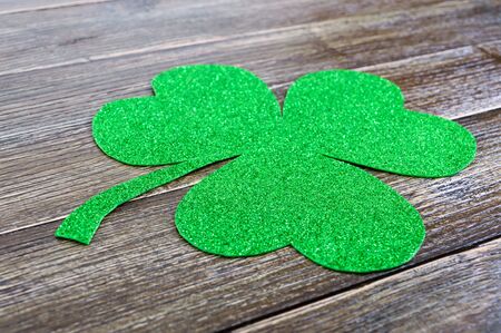 Green shamrock on a wooden background. St.Patrick 's Day background. Symbol of Ireland