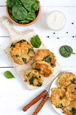 Pancakes with cabbage and spinach. Juicy vegetable cutlets with sour cream. Diet menu. Lenten dish. The top viewの写真素材