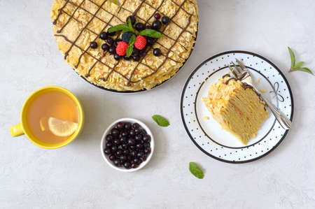 Classic Napoleon cake. Delicious festive layered dessert with puff pastry and custard decorated with...