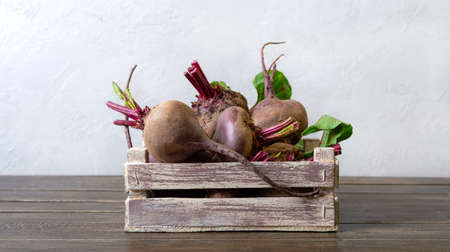Fresh beets in a wooden box on the table. Vitamin-rich vegetables.