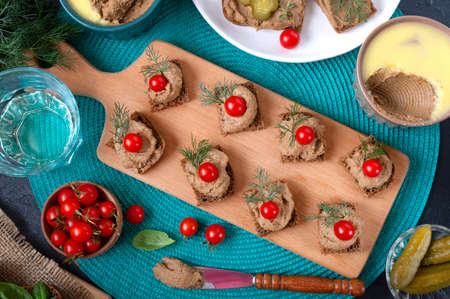 Canapes with rye bread, liver pate, cherry tomatoes. Breakfast snack. Top view.の写真素材