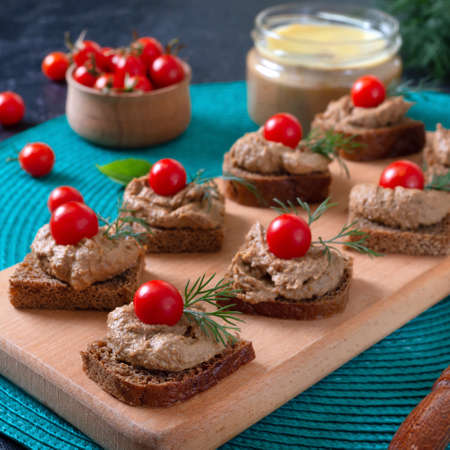 Canapes with rye bread, liver pate, cherry tomatoes. Breakfast snack.の写真素材