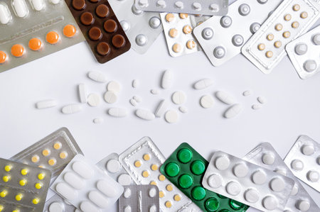 Various health pills, antibiotics, vitamins, scattered tablets, blisters. Healthcare and pharmacy theme. The top viewの写真素材