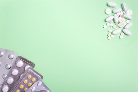 Medical background, copy space. Various health pills, antibiotics, vitamins, scattered tablets, blisters. Social health problems concept. Pharmacy theme.の写真素材