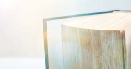 Macro view of the book. Abstract background. Fan of book pages with magic bokehの写真素材