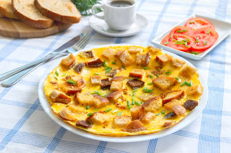 Omelet with pieces of toasted bread and a cup of coffee. Delicious and nutritious breakfast.