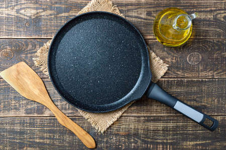 Culinary background with empty nonstick pancake pan. rustic style.の写真素材