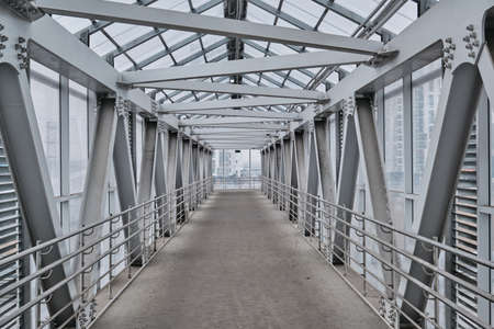 Metal covered pedestrian bridge across the highway.の写真素材
