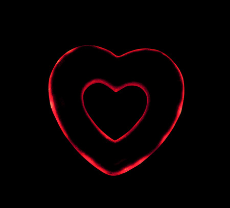 artificial red heart on a black backgroundの写真素材