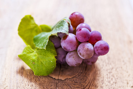 Grapes on a old wooden tableの写真素材