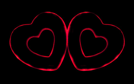 Two artificial red heart on a black backgroundの写真素材