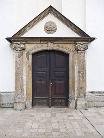 All-seeing eye above old wooden doors with the columns of Templeの写真素材