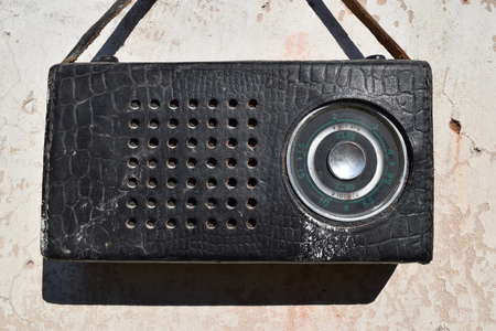 Old radio in a leather case with small strapの写真素材