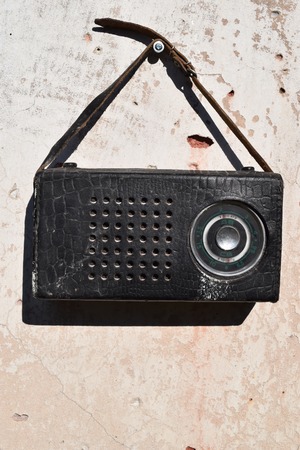 Old radio in a leather case with small strapの写真素材