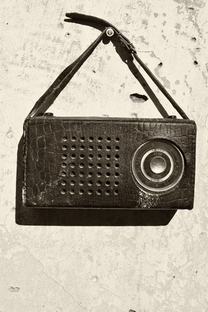Old radio in a leather case with small strapの写真素材