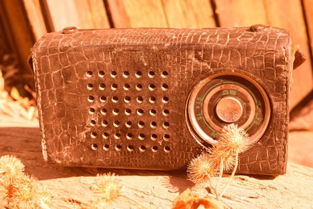 Old radio in a leather case with small strapの写真素材