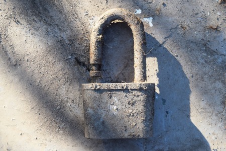 Rusty lock on the background of the iron tableの写真素材