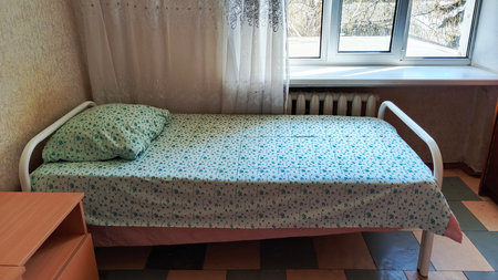 Large bed, chest of drawers, armchair and window with curtains in bedroom. Interior designの写真素材