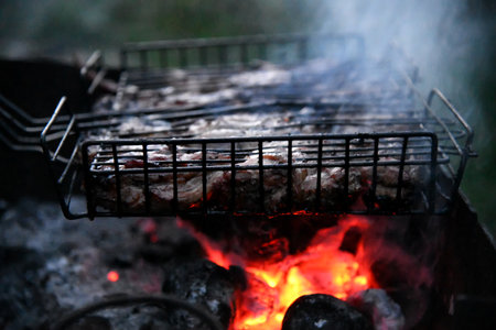 BBQ coal brings the authentic smoky flavor to your grilling, creating perfectly charred meats and veggies. It's the heart of every classic barbecue experience.の写真素材