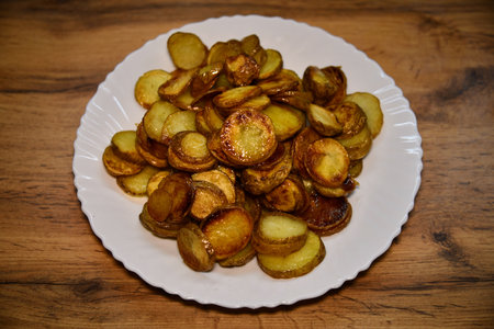 Golden fried potato strips served with cheese and flavorful sauceの写真素材