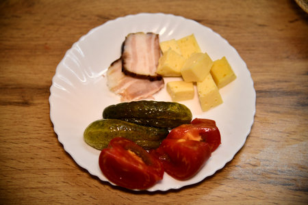 Overhead shot of a colorful plate with cherry tomatoes, arugula, and goat cheeseの写真素材