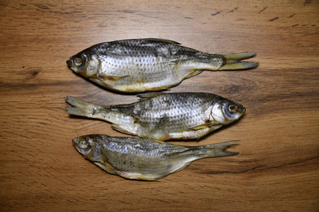Dry salted fish displayed in a busy market stall, market, seafood, salted fish, dry, traditional, preserved, market stallの写真素材