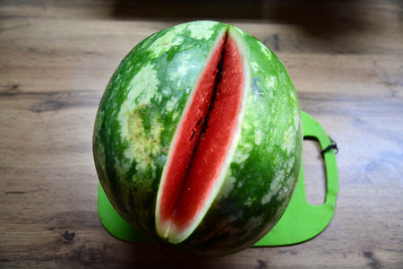 Fresh sliced watermelon on brown wooden table backgroundの写真素材