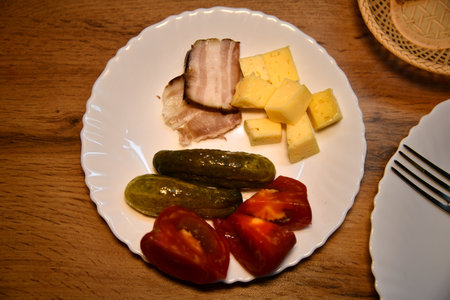 Overhead shot of a colorful veggie flatbread with cherry tomatoes, arugula, and goat cheeseの写真素材