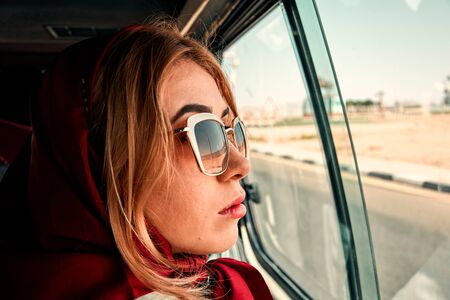 Trendy girl traveling by car. Travel conceptの写真素材