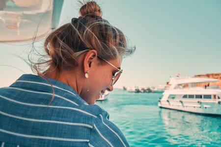 Woman on a yacht enjoying the beautiful vacation.の写真素材