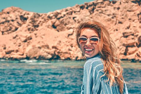 Woman on a yacht enjoying the beautiful vacation.の写真素材