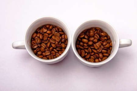 two cups with coffee beansの写真素材
