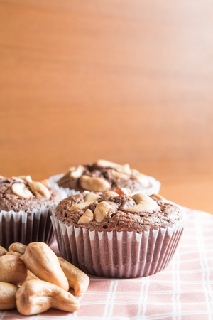 Cup of Chocolate Cake Brownies With Cashew nuts On Wooden Backgroundの写真素材